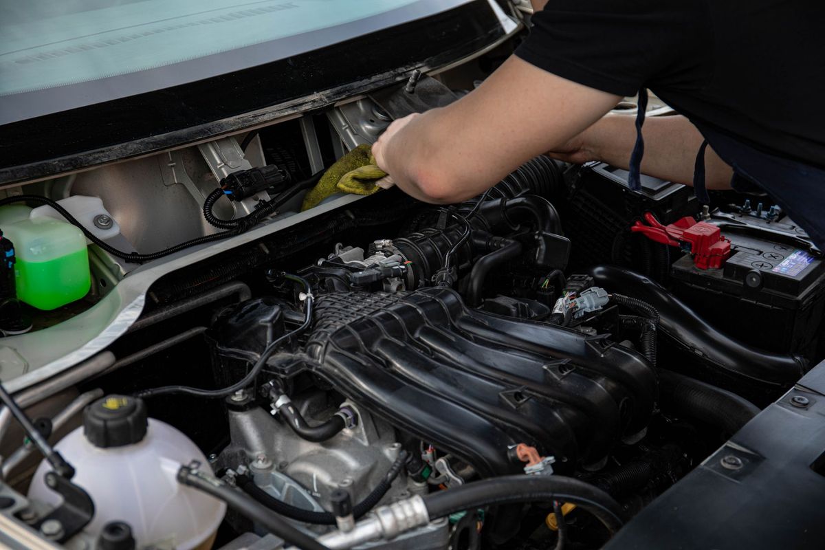 mechanic checking car battery