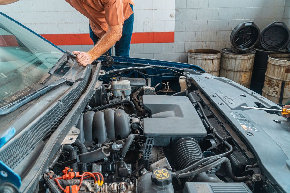 mechanic checking car battery