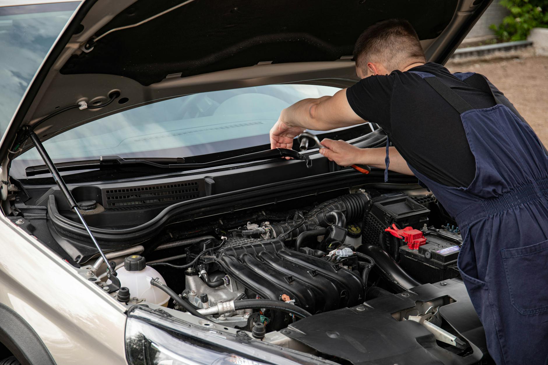 mechanic checking car battery
