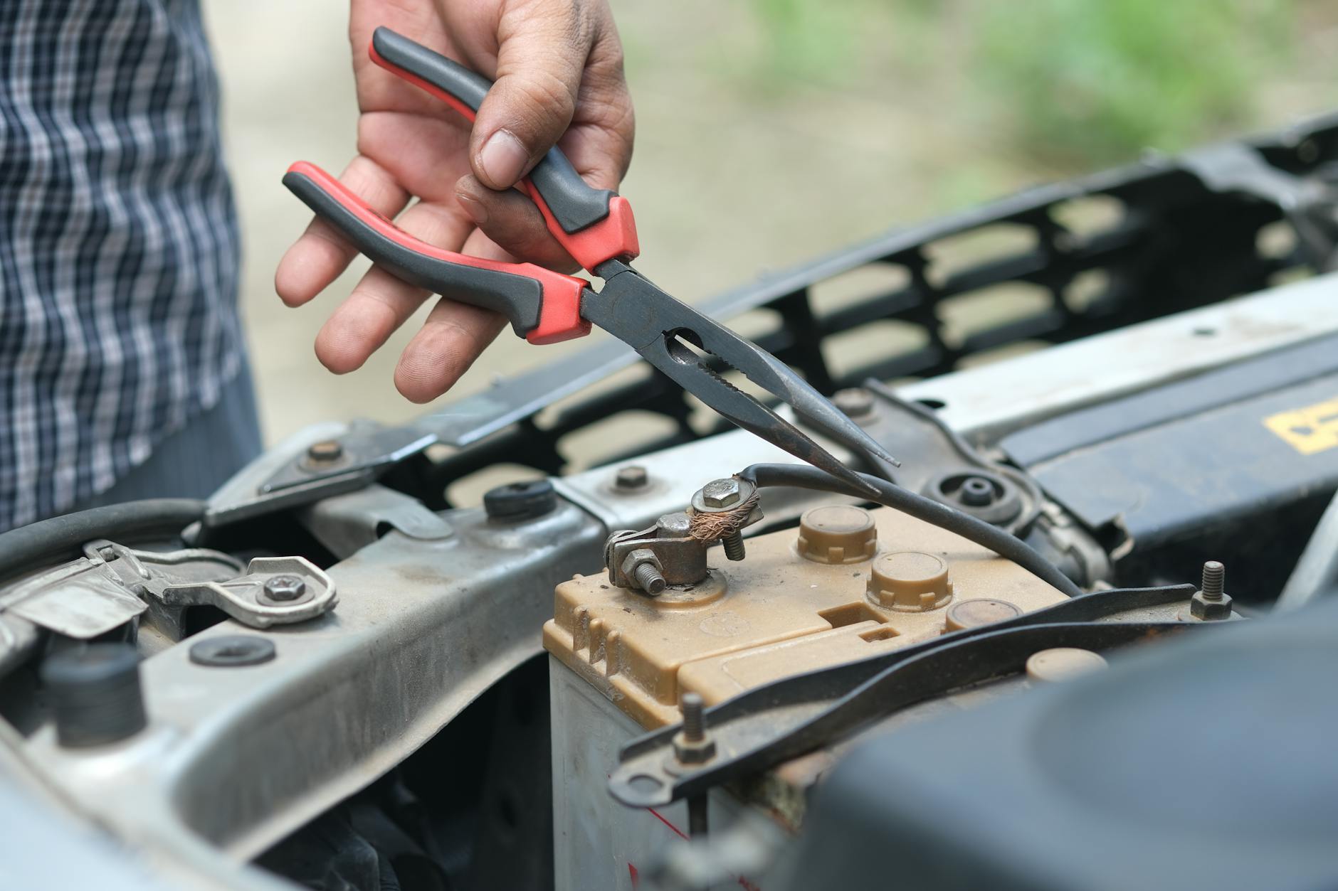 mechanic checking car battery