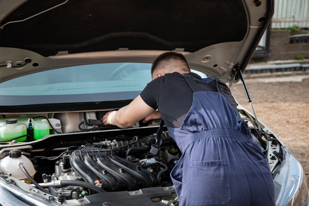 mechanic checking car battery