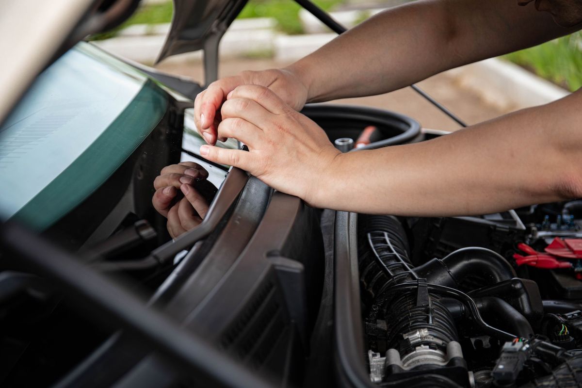 mechanic checking car battery