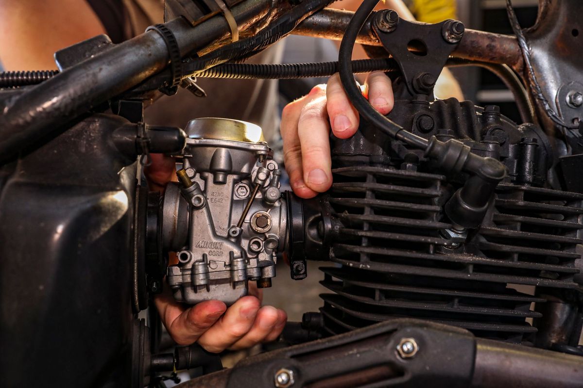 mechanic checking oil dipstick